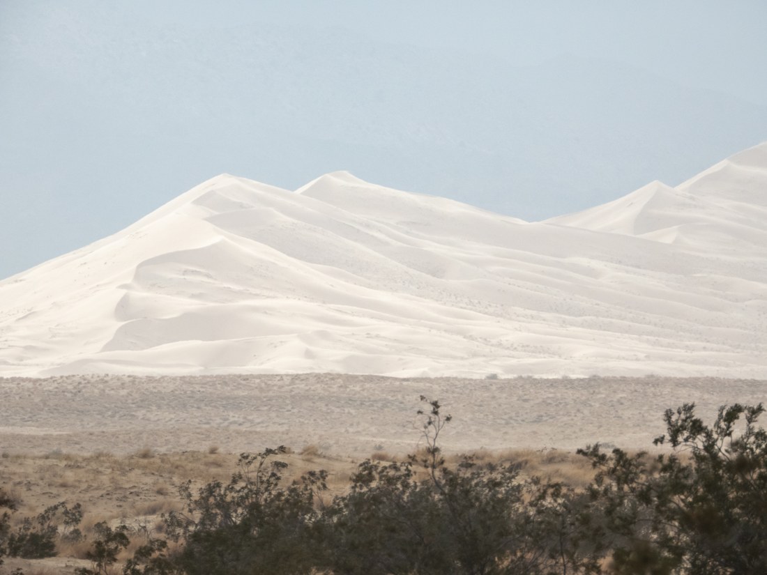 Sand dunes and distant mountains at Kelso Dunes in Mojave National Preserve